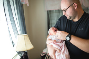 baby girl in nursery with dad