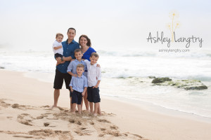 family poses at beach