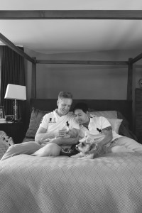 dads hold their baby boy in their bedroom