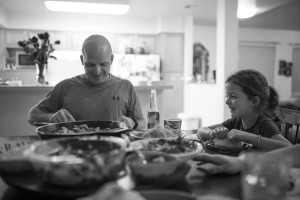 dad serves dinner to daughter