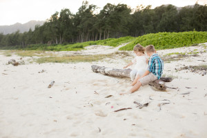 kids play on log on beach