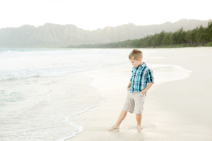 boy dips toes in ocean