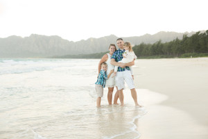 family poses on beach