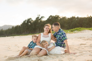 family poses on beach