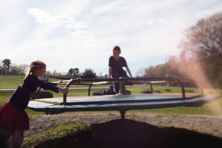 free-lens images of kids on a merry go round