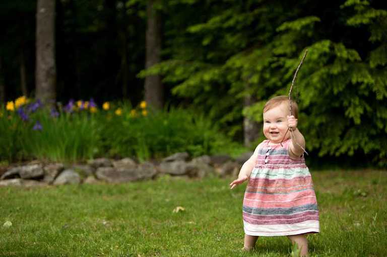 baby plays in grass 