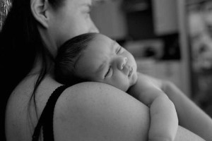 baby sleeping on moms shoulder