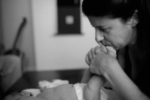 mom kissing baby feet