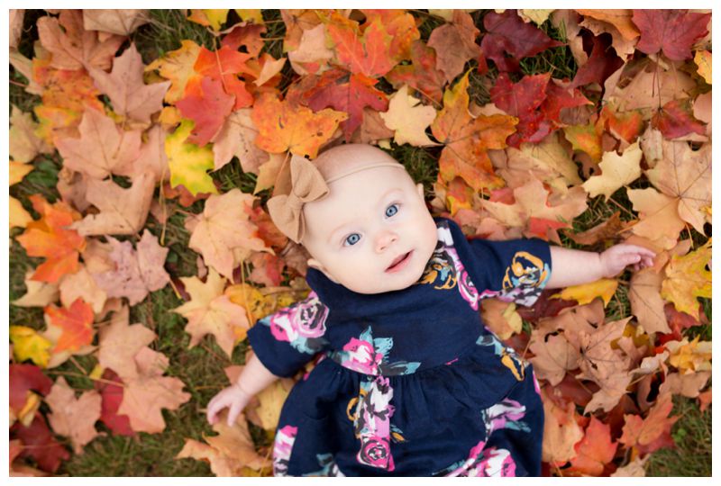 baby girl in leaves