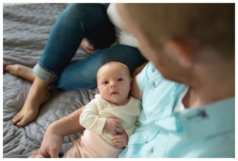 newborn baby in dad's arms