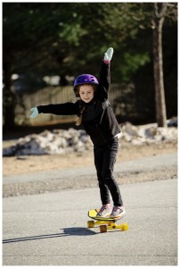 girl skateboards with mittens