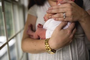 close up images of details of baby while snuggled in moms arms