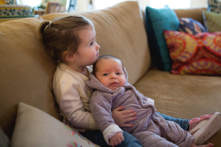 sister holds baby in portland maine