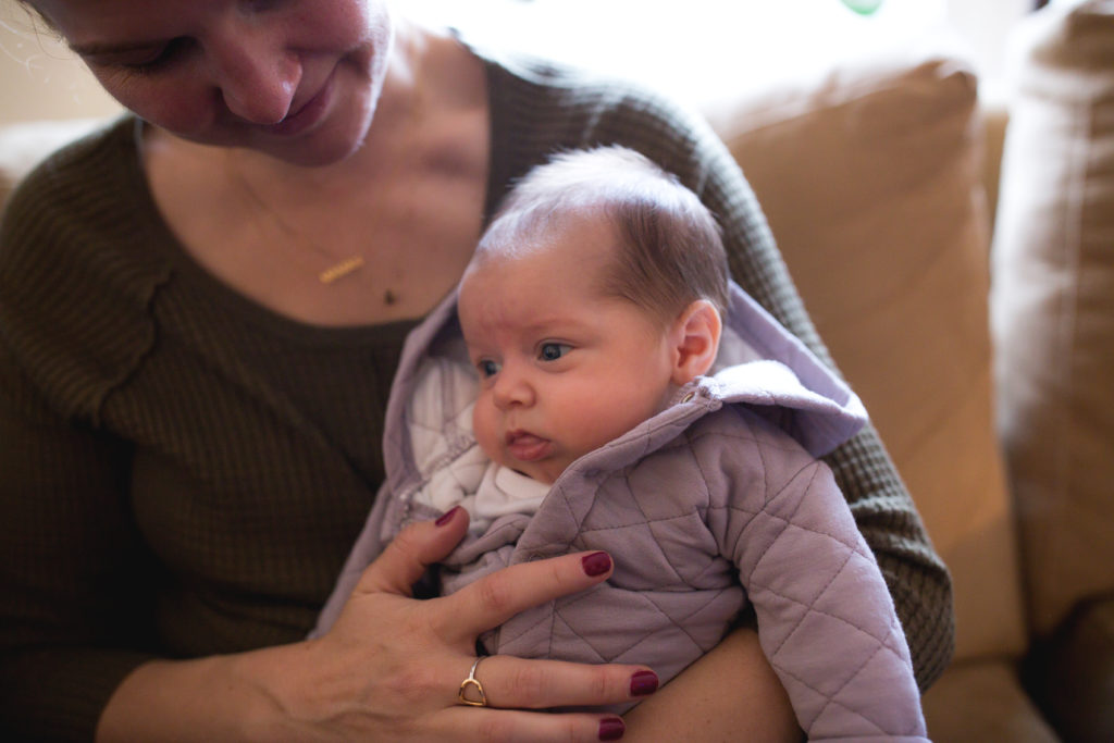 baby snuggles with mom in portland maine