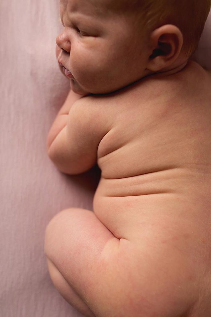 baby girl shows her chub