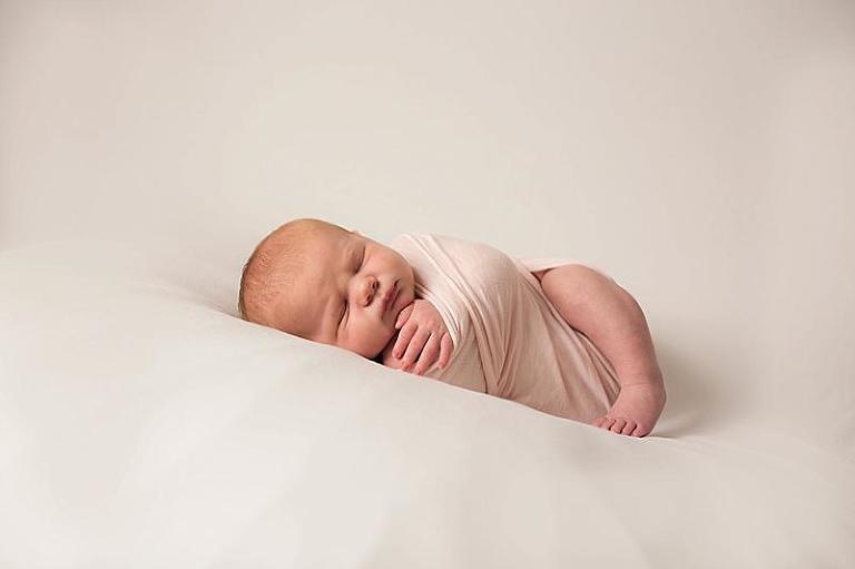 newborn baby on blanket