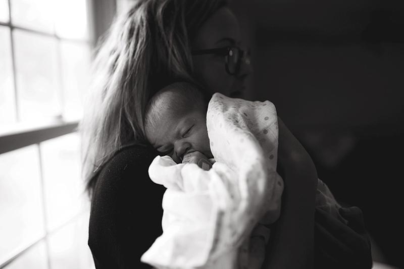 mom snuggles baby girl