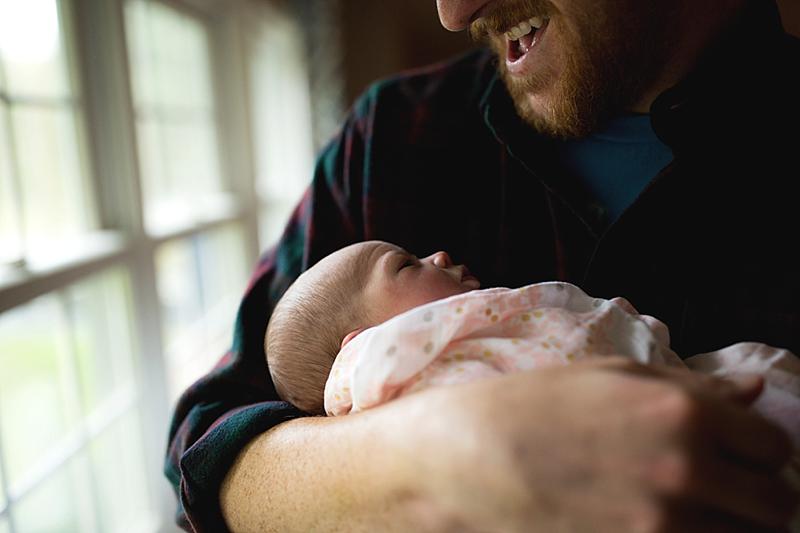 dad smiles at baby girl