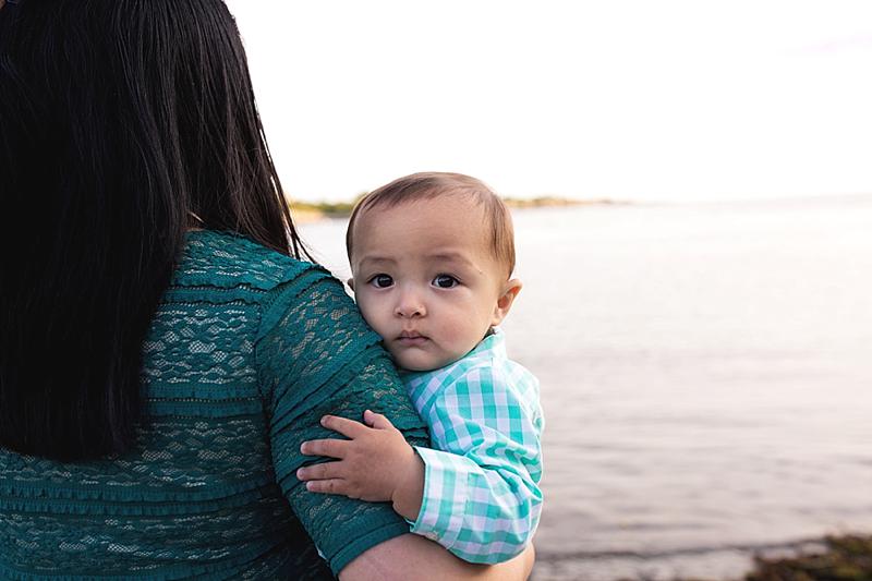 baby looks behind mom