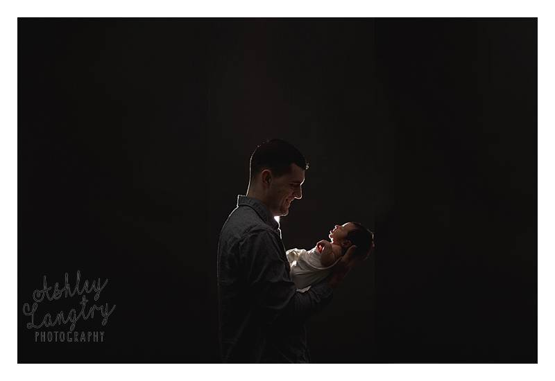 silhouette of dad and baby