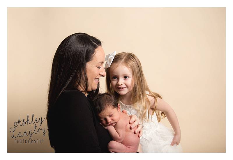 mom and girl with newborn