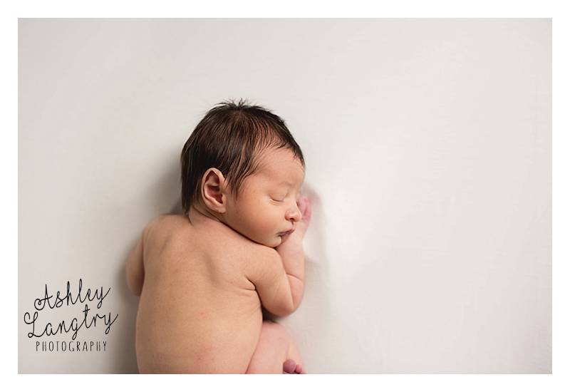sleeping baby on white blanket
