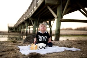 one year old boy cake smash on the beach
