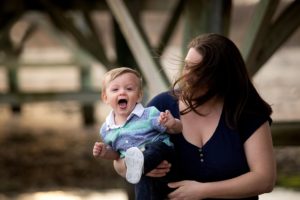 little boy laughs in the wind
