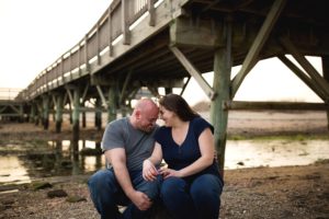 a couple laugh together on the beach