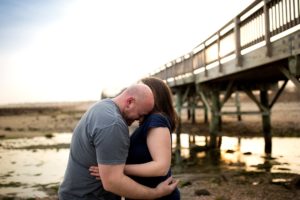 a couple pose together on the beach