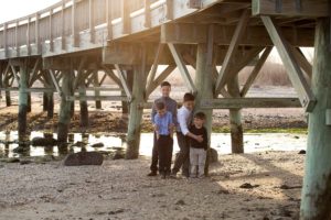 brothers play together under pier