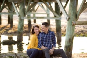 happy couple sitting on rocks