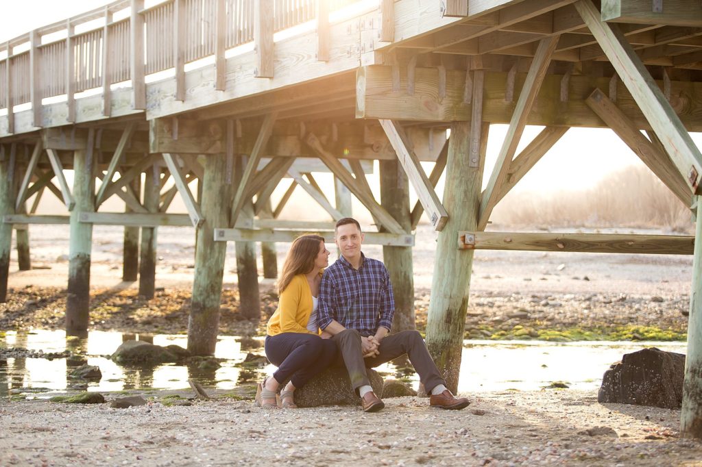 a couple snuggles on beach