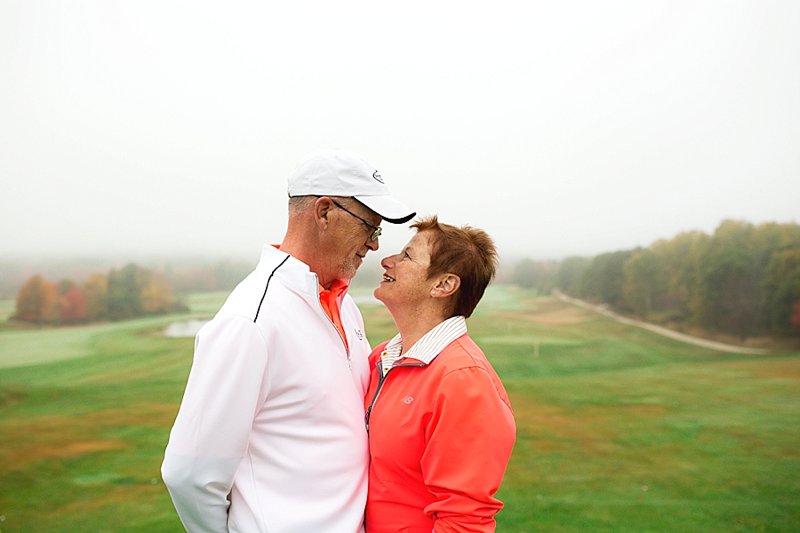 couple poses at golf course
