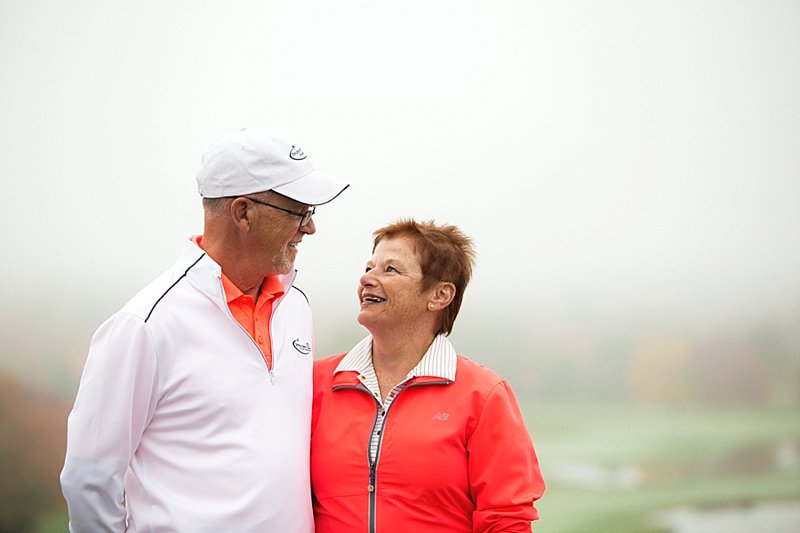 maine couple posing with fog in background