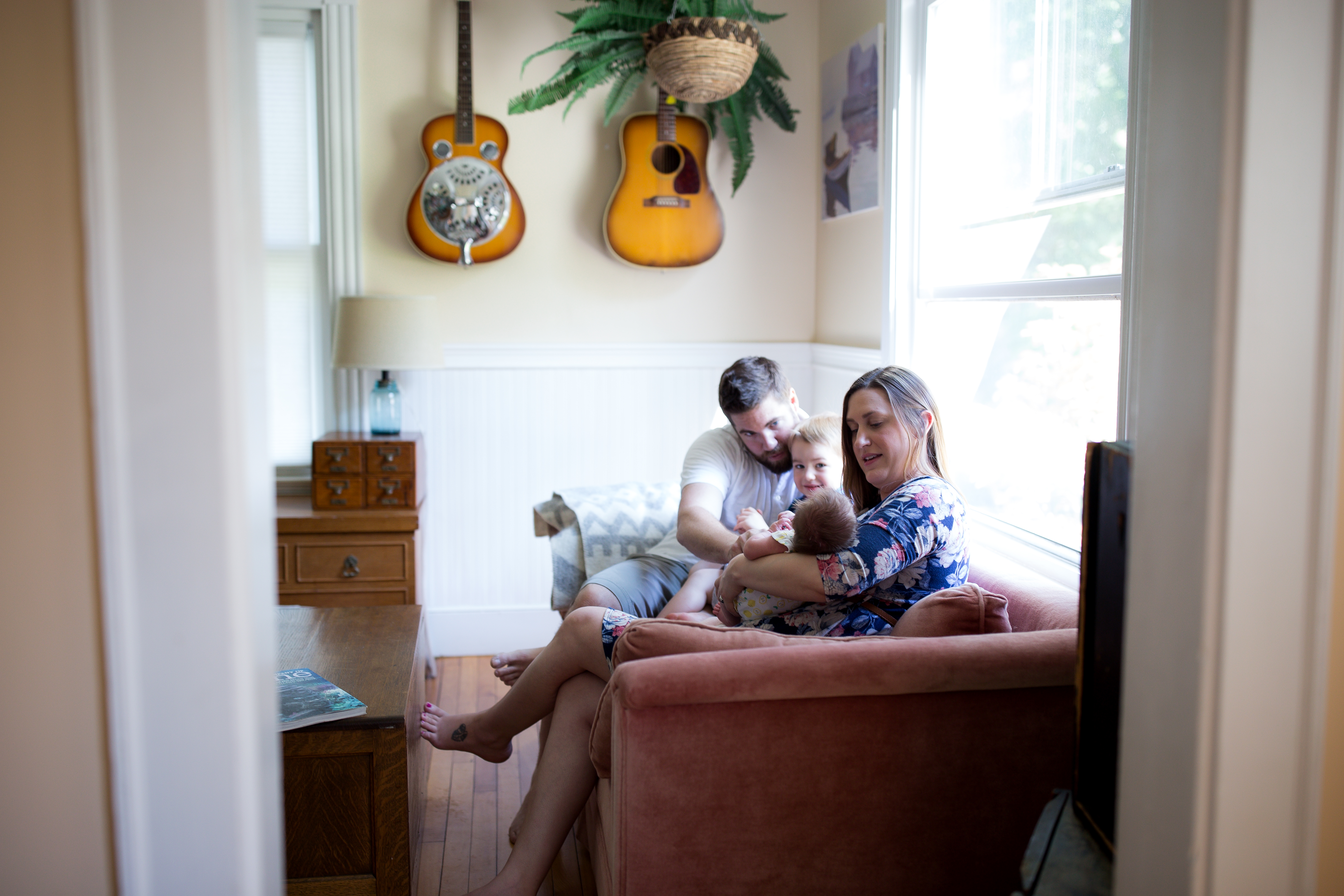 family rests on couch