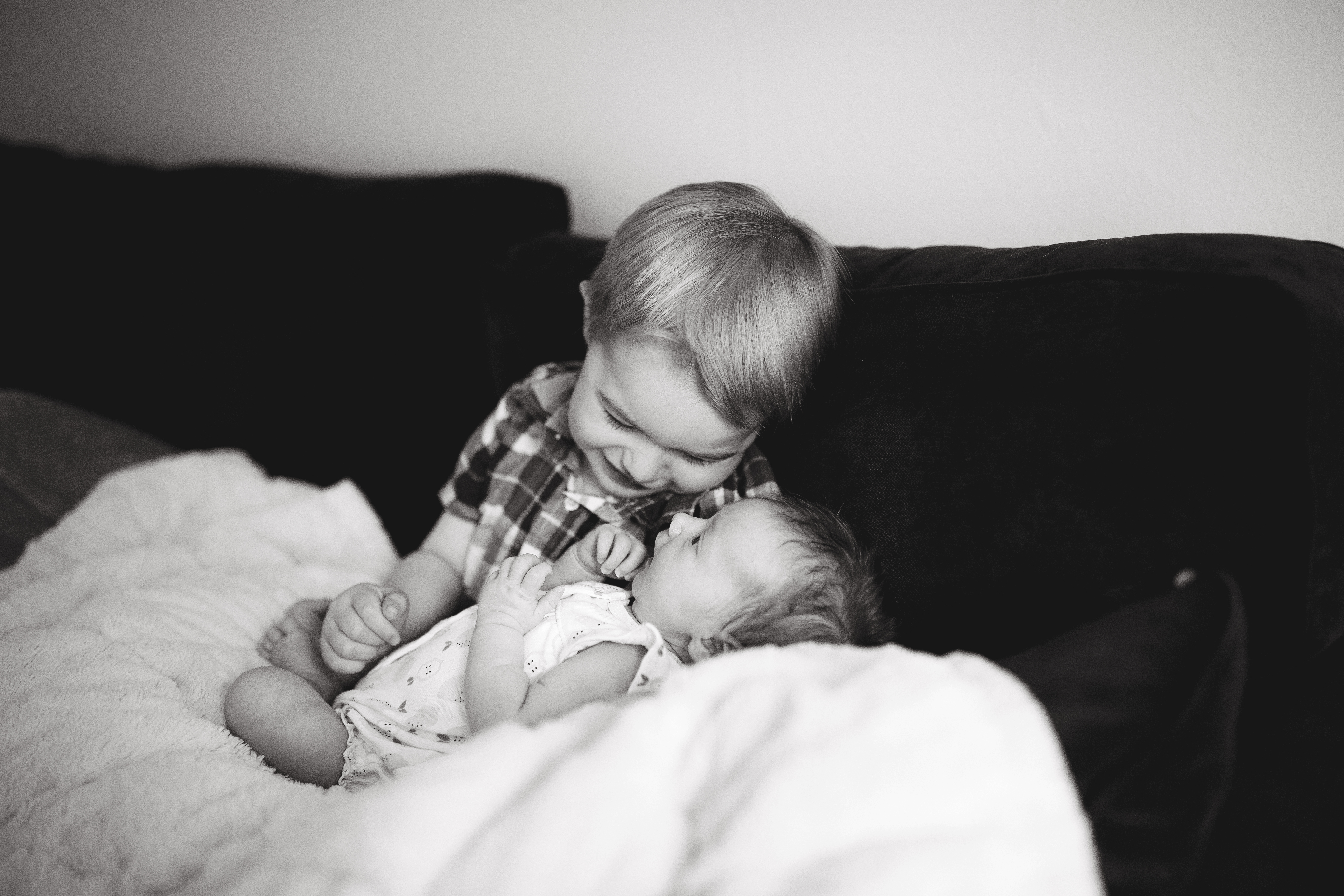 big brother admires baby girl