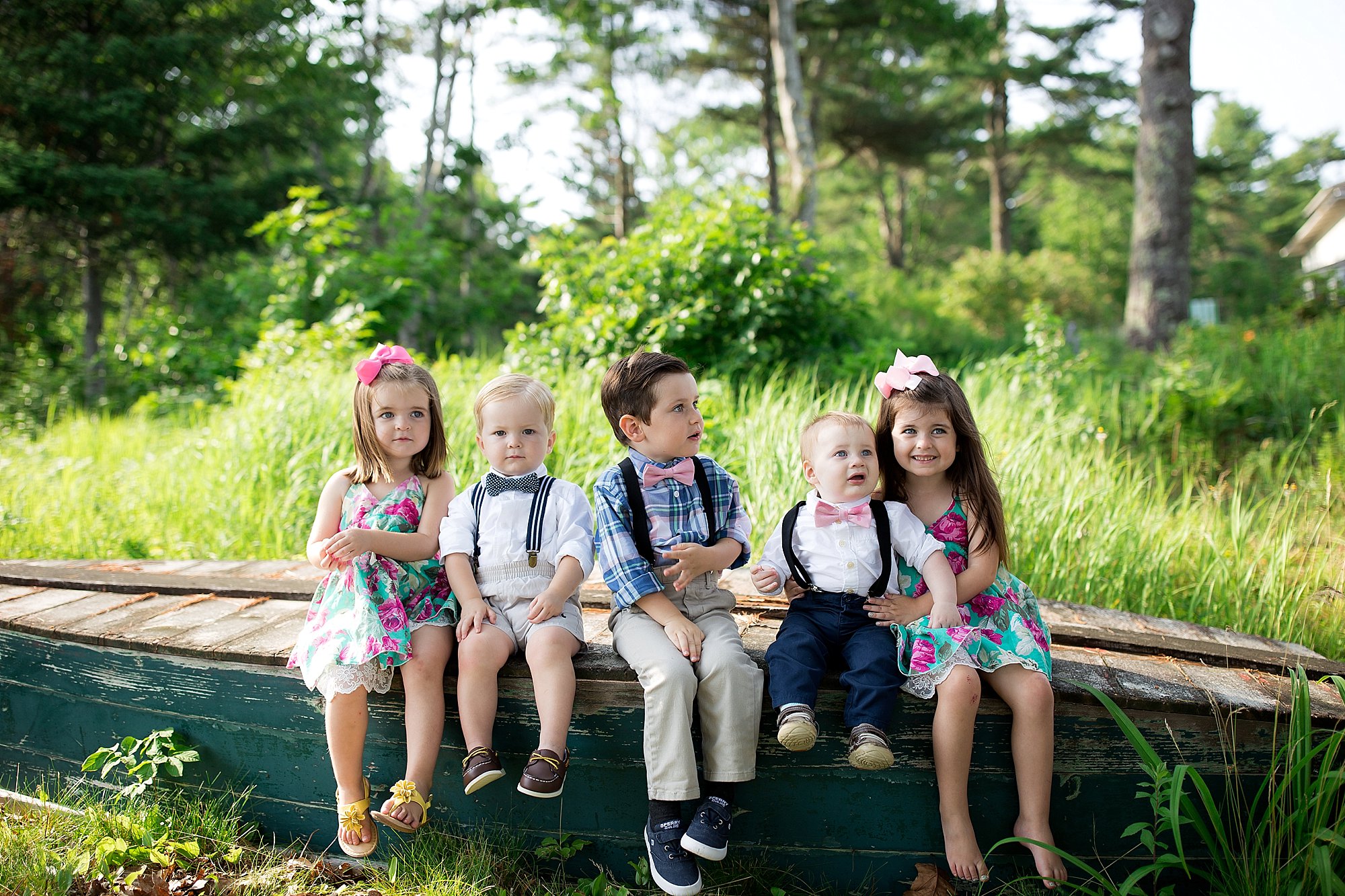 five kids sit on a canoe in Boothbay