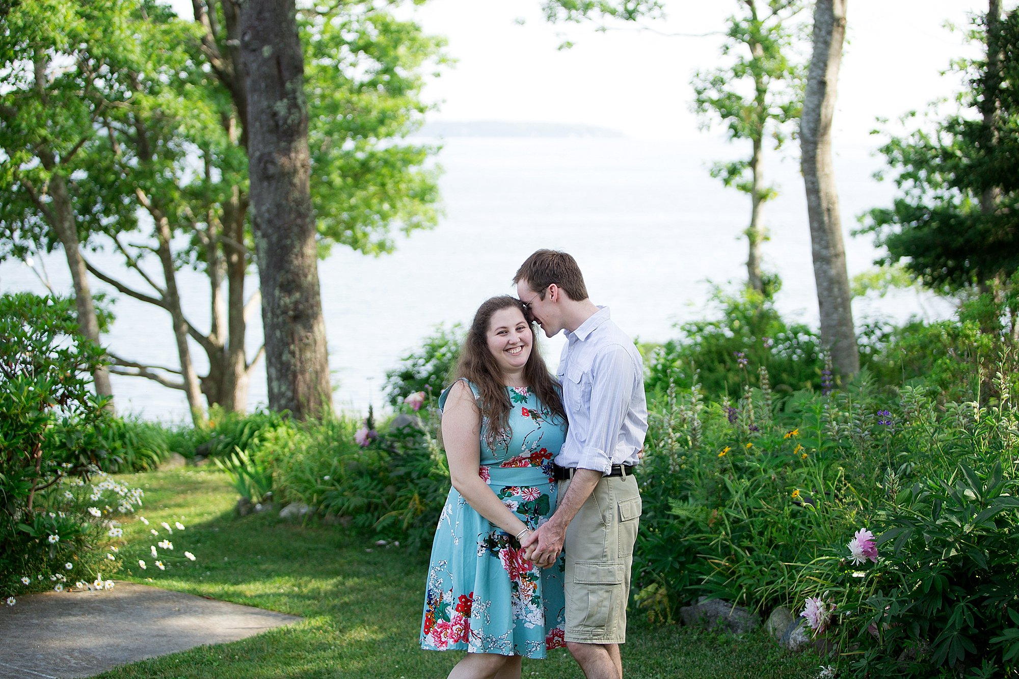 new couple embraces in the grass