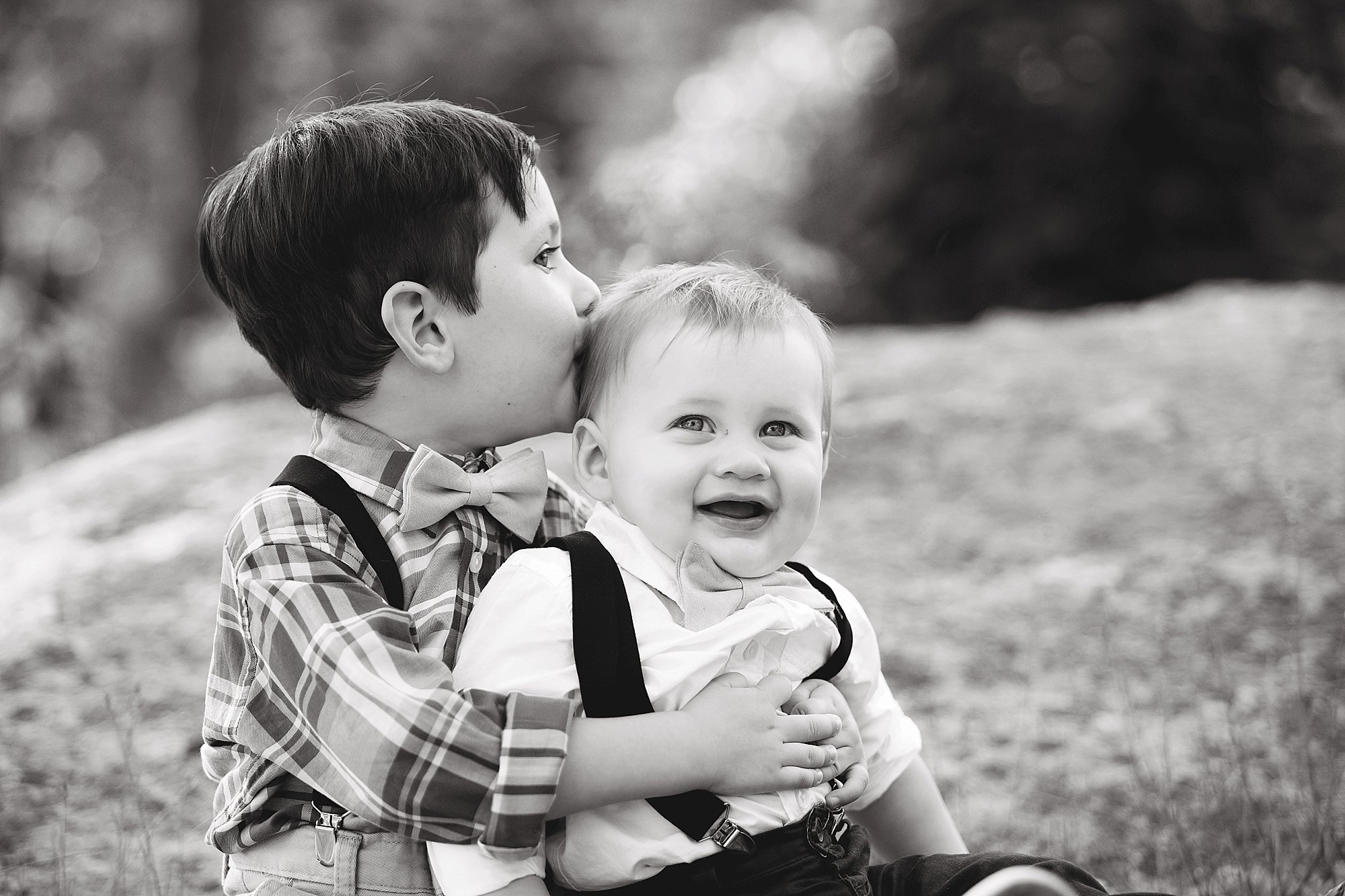 big brother kisses baby brother in Boothbay Maine