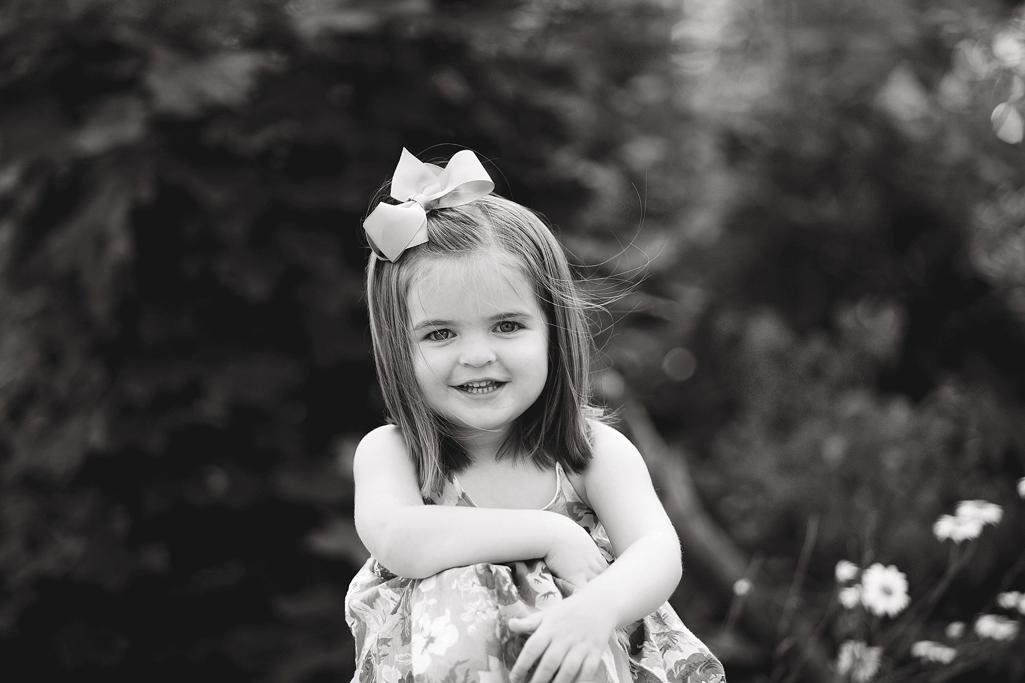 Little girl hugs knees