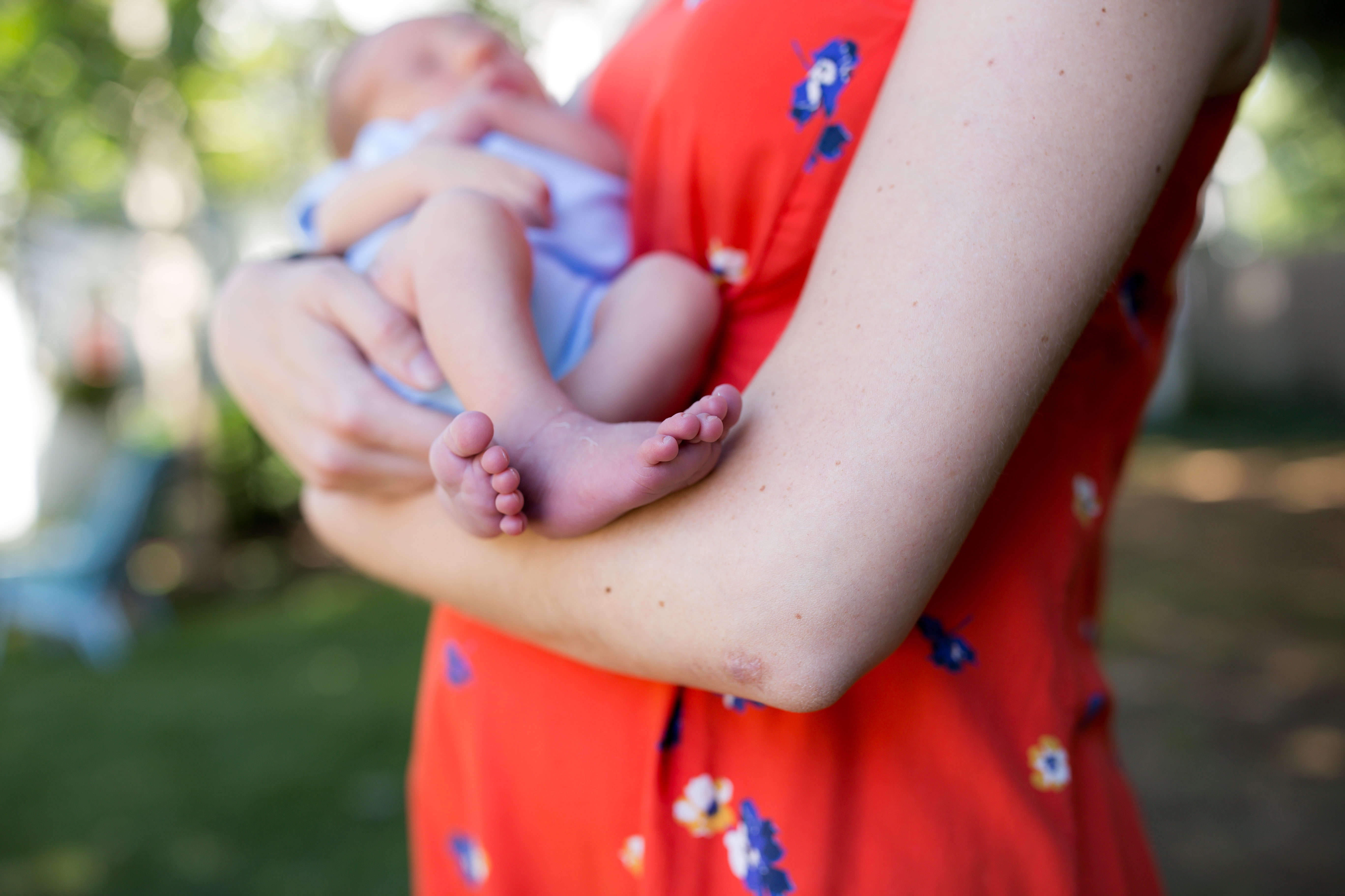 baby is cradled in moms arms