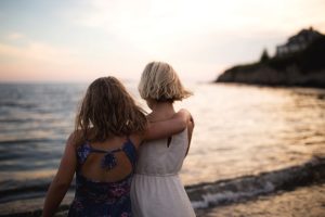 sisters gaze at ocean at lands end