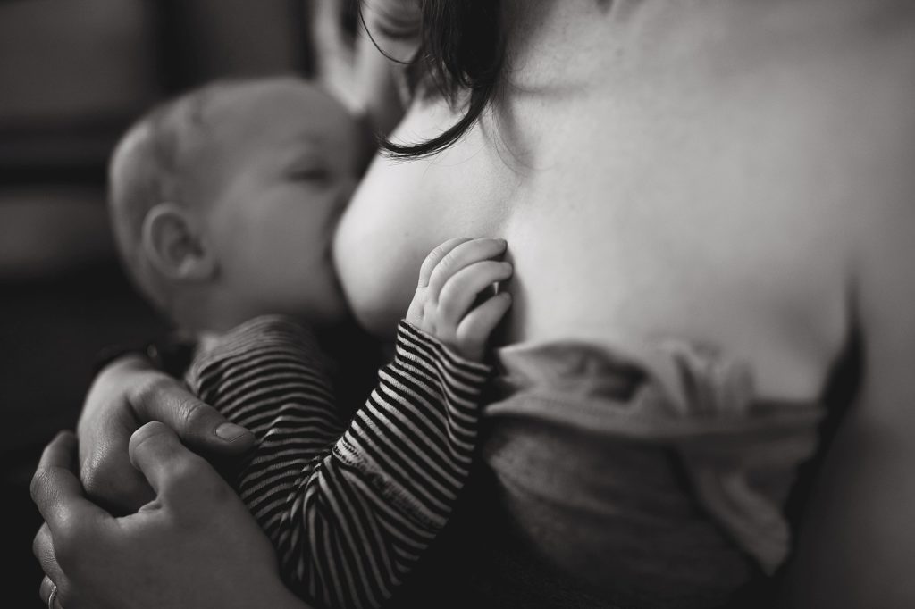 baby's hand on moms chest