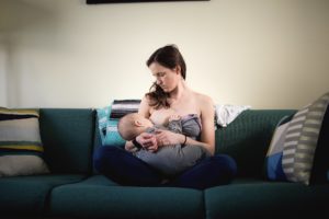 breast-feeding on green couch