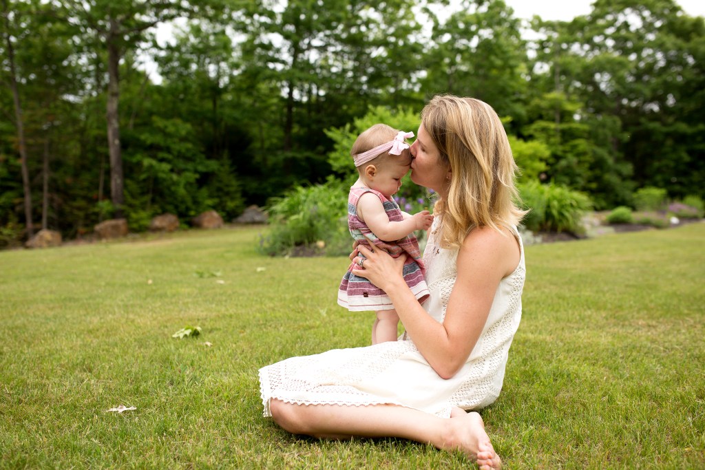 mom kisses baby girl